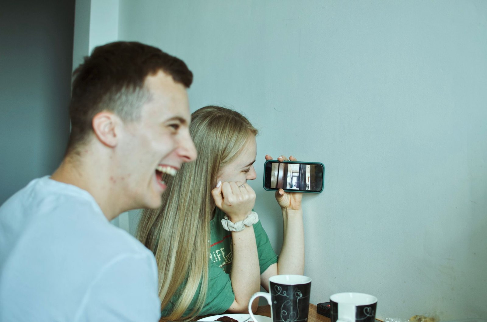Woman laughing during a video call, staying close to her partner from far away