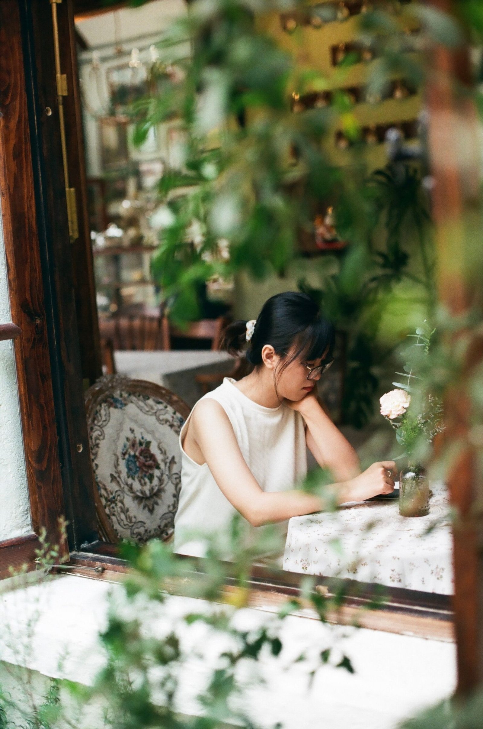 Woman sitting by a cafe window thinking about what she found out