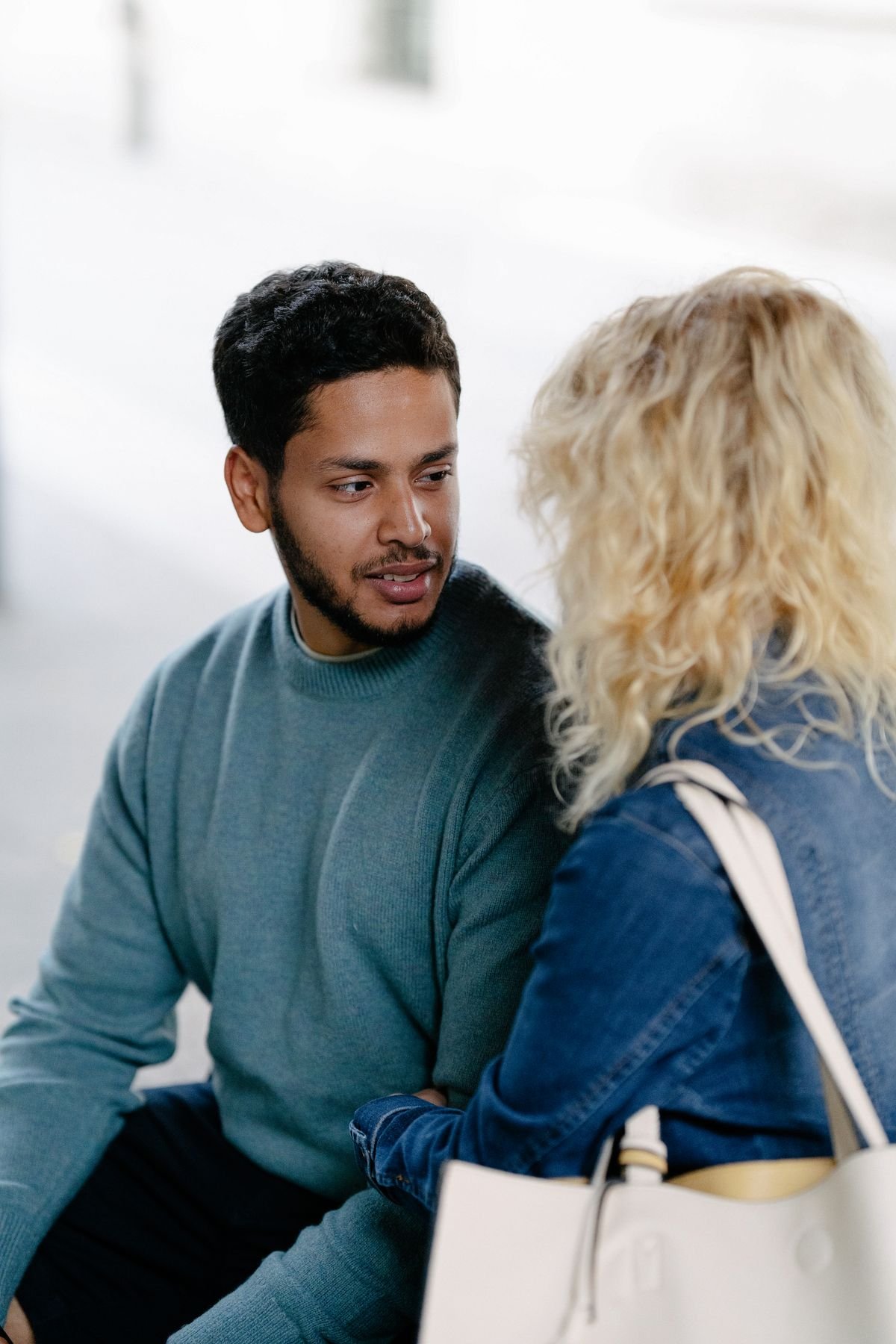 Couple sitting outside talking slowly about something that scares her
