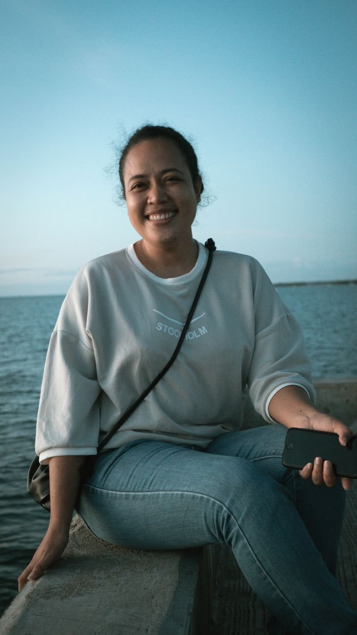 Woman smiling outdoors feeling steady again weeks after a date ghosted her