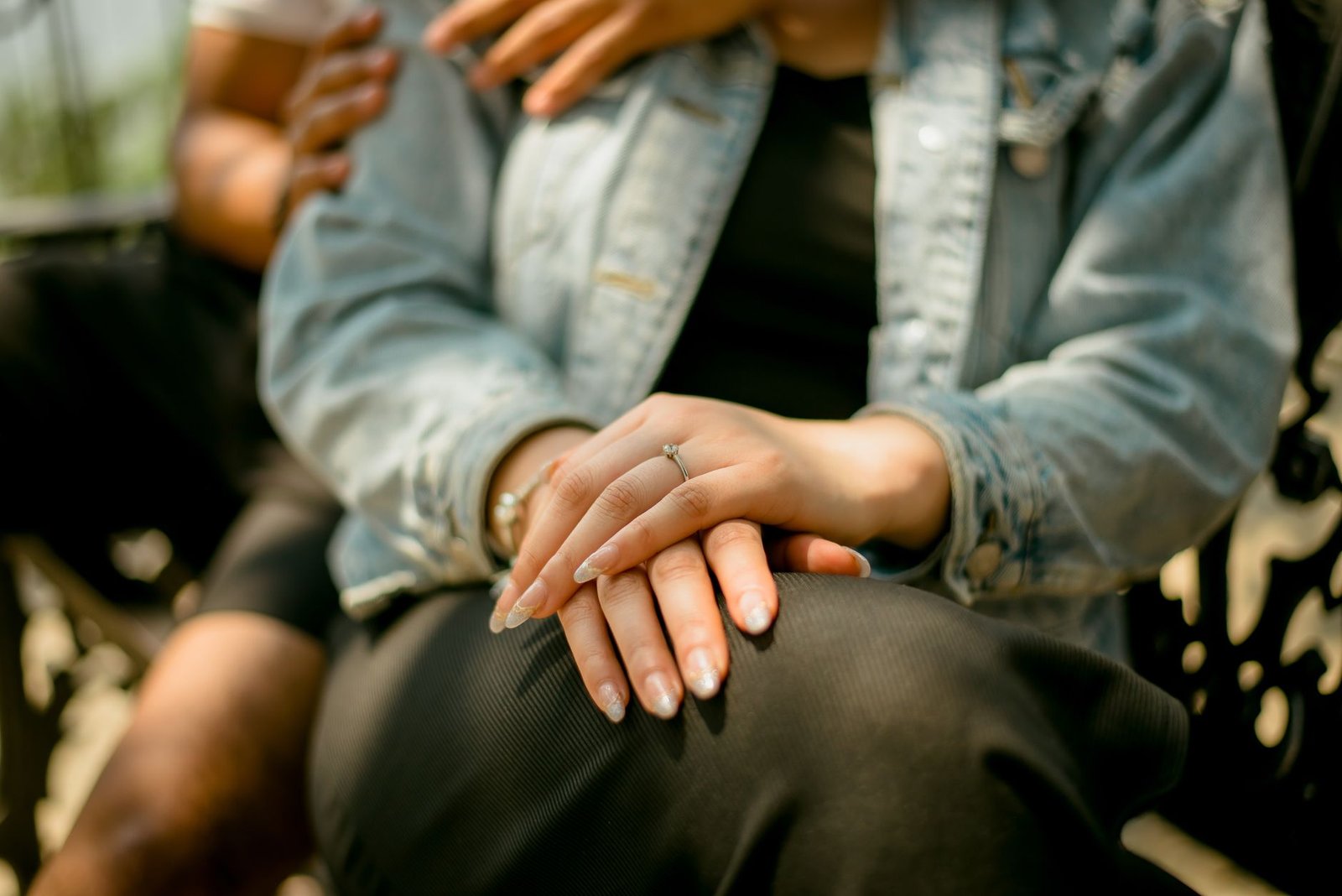 Engaged couple holding hands and talking through their long engagement timeline