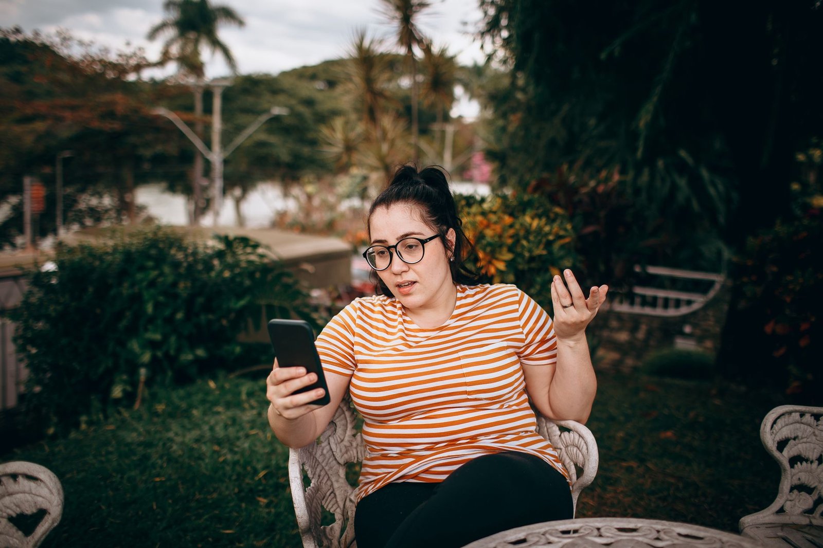 Woman reading a text reply after asking a direct question about repeated cancellations