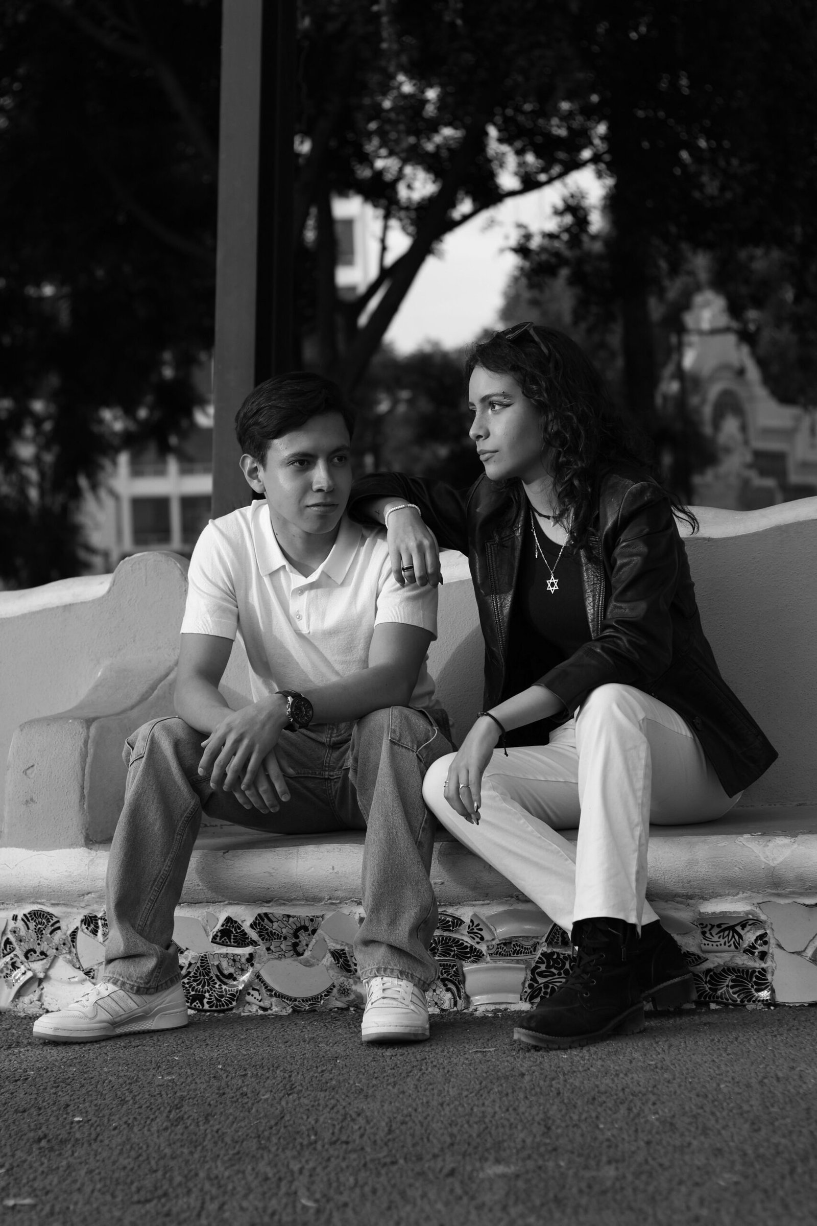 Man and woman sitting apart during a quiet conversation about trust