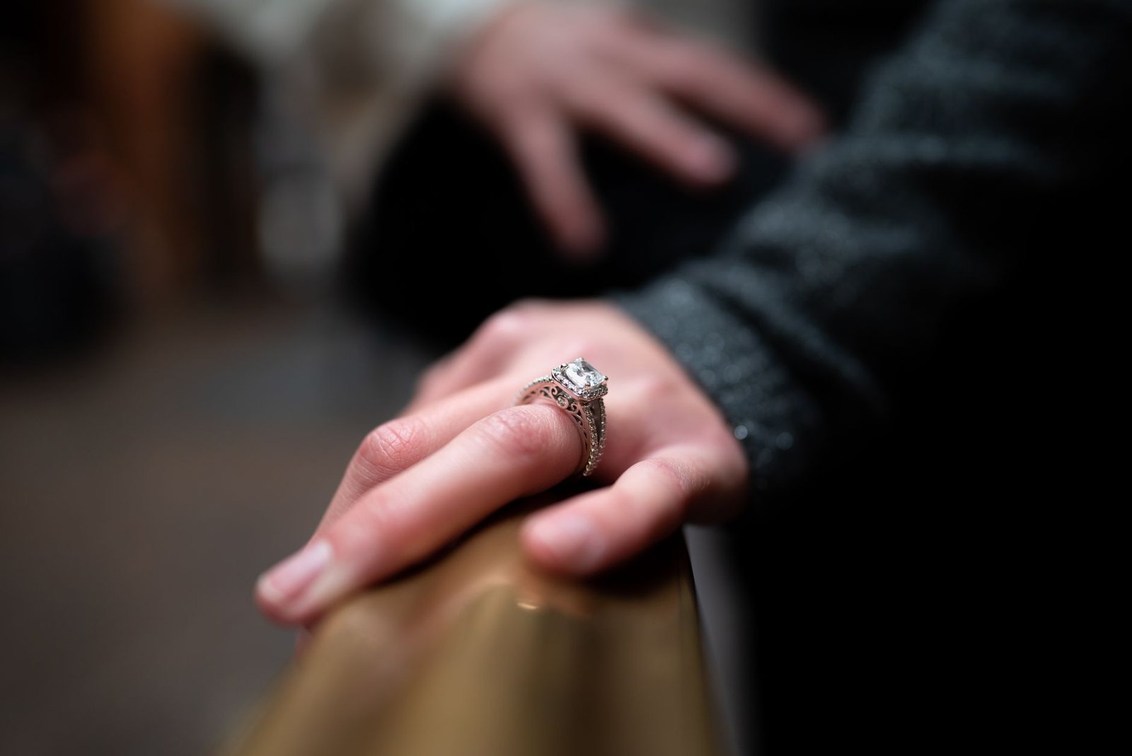 Close up of an engagement ring on a hand after a family finds out before yours does