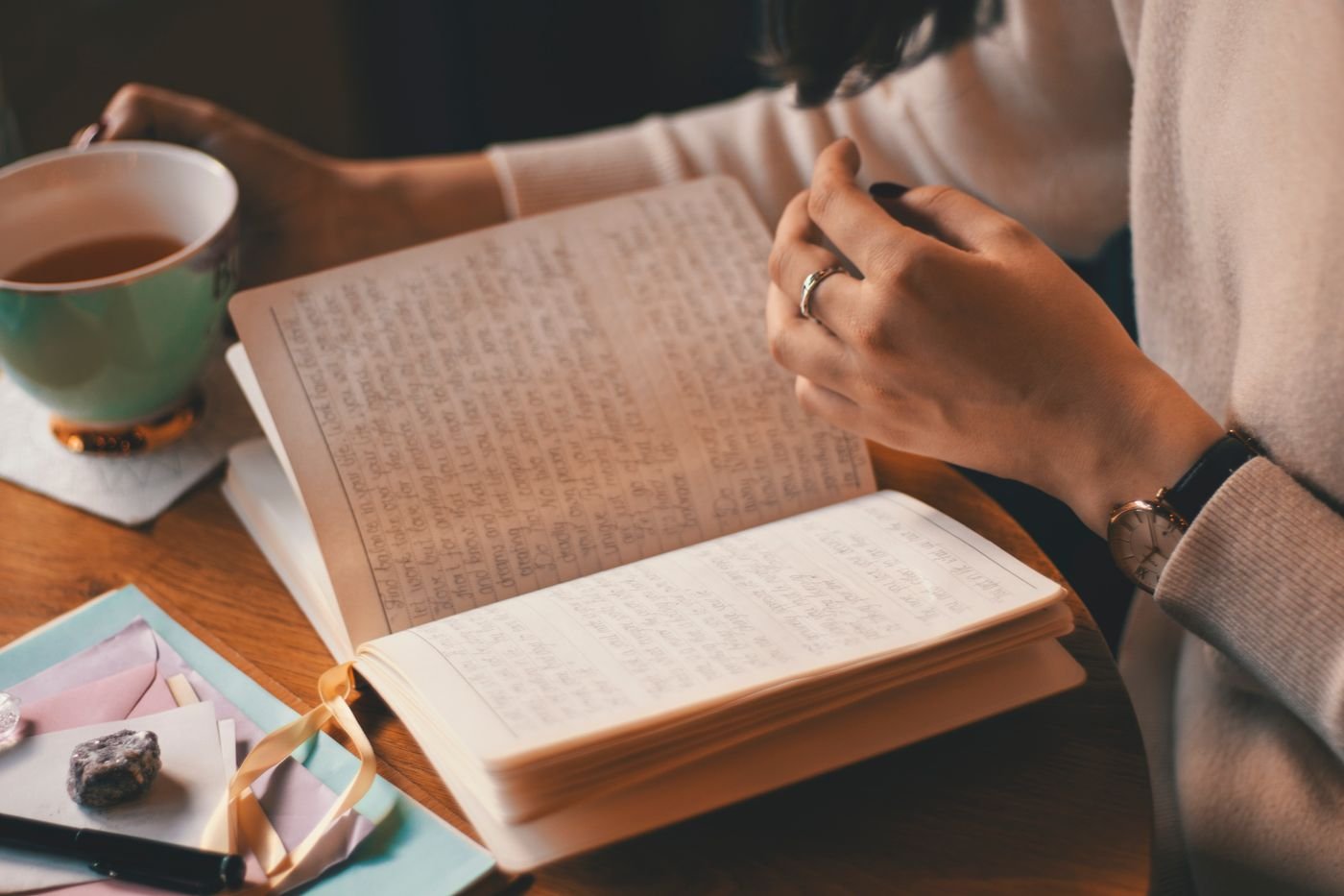 Woman writing in a journal with coffee while thinking through her long distance relationship rules
