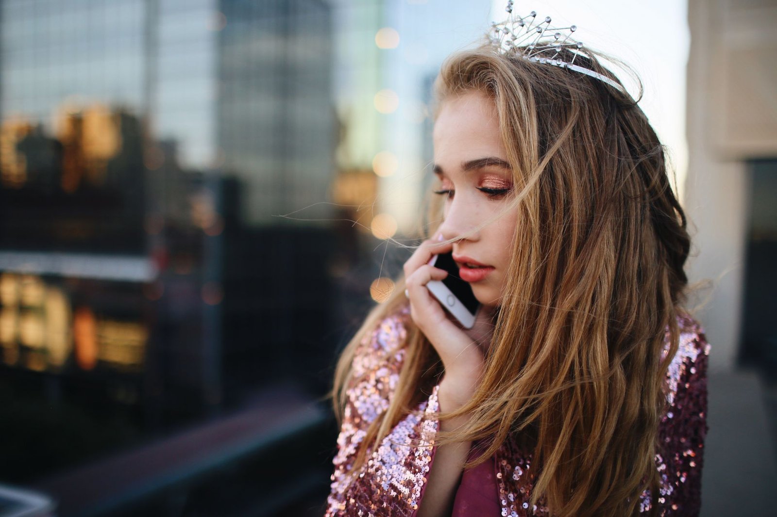 Woman on an evening phone call from her balcony in a long distance relationship