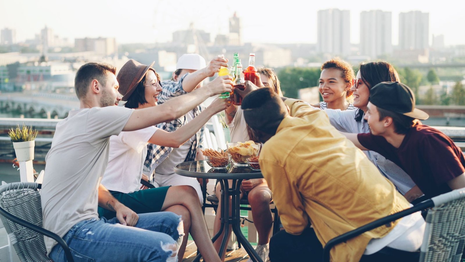 Rooftop birthday party crowd talking on a summer evening