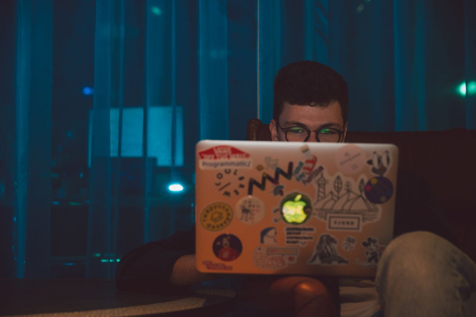 Man focused on his laptop screen late in the evening