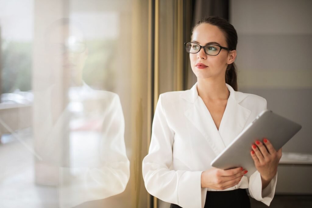 Woman looking thoughtful by an office window