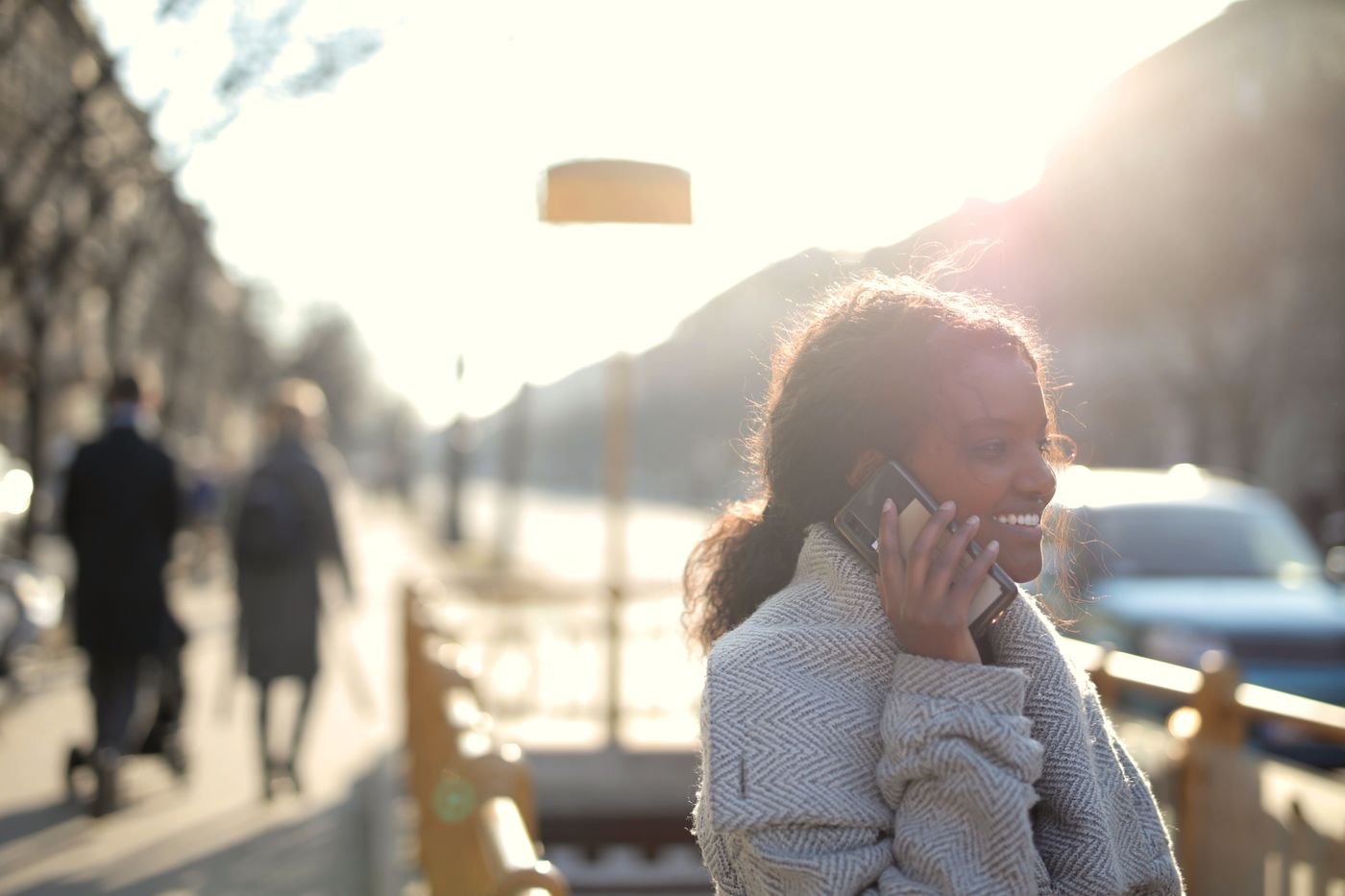 Woman smiling during a phone call, a daily habit that keeps long distance relationship rules working