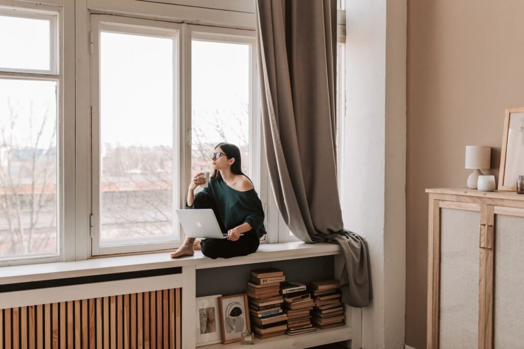 Woman sitting with a hot drink deciding whether to answer her ex boyfriend