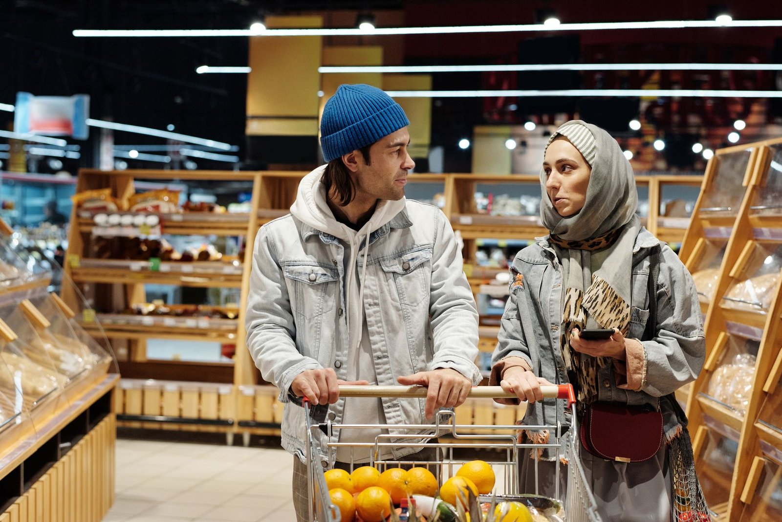 Couple comparing items in the grocery aisle