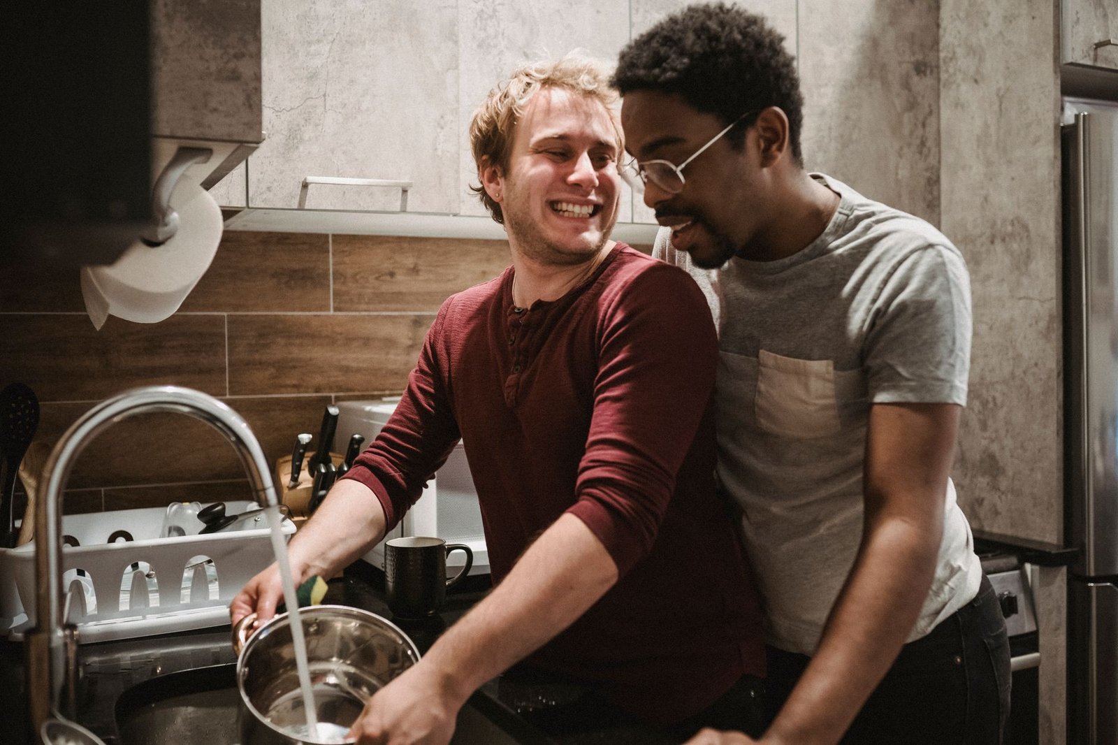 Couple washing dishes together in the kitchen
