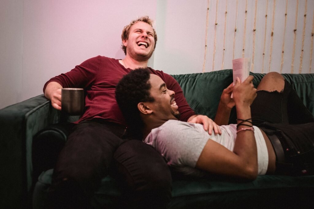 Couple laughing together at home after planning a date