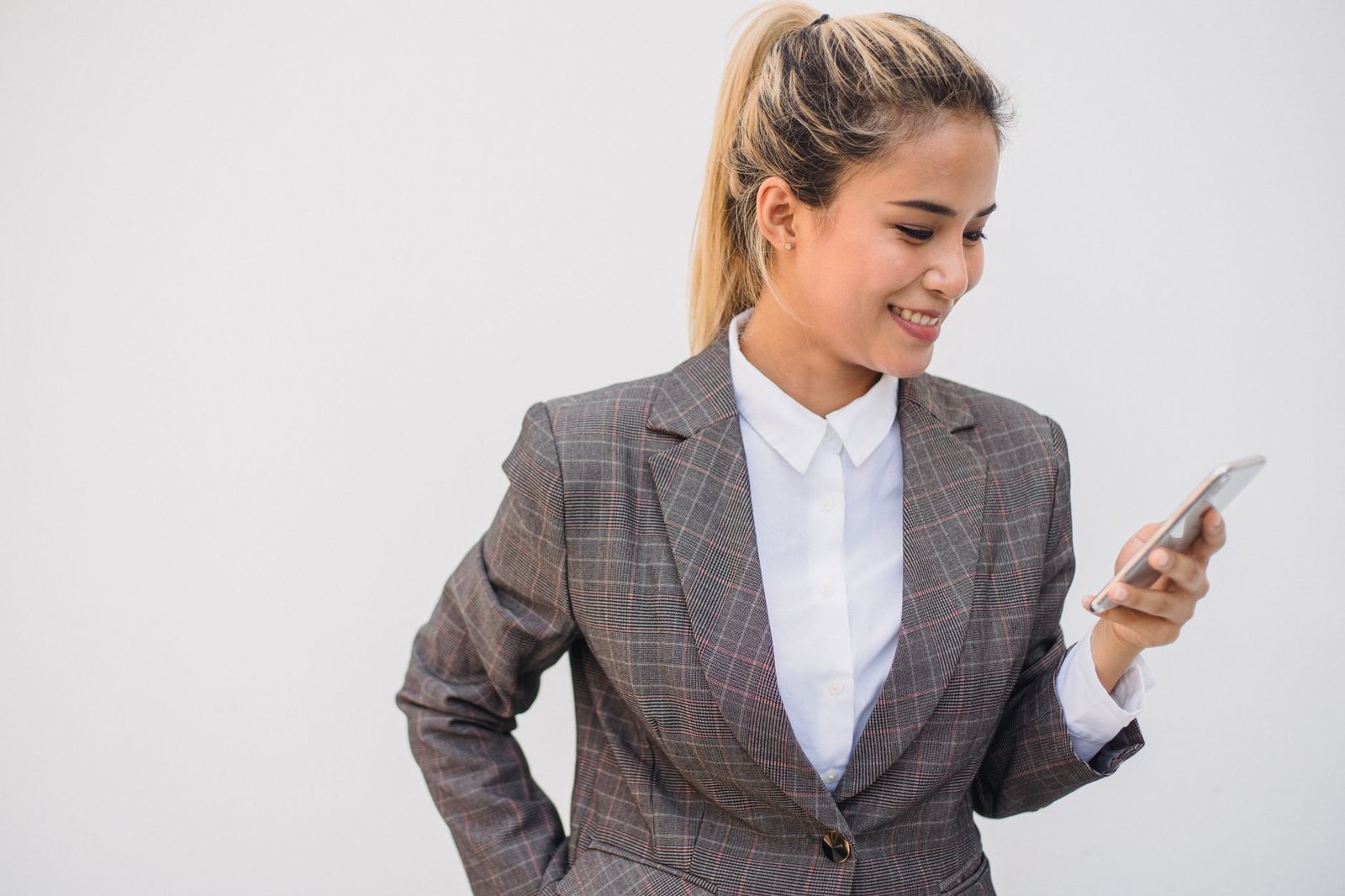 Woman smiling while texting her long distance partner on her phone