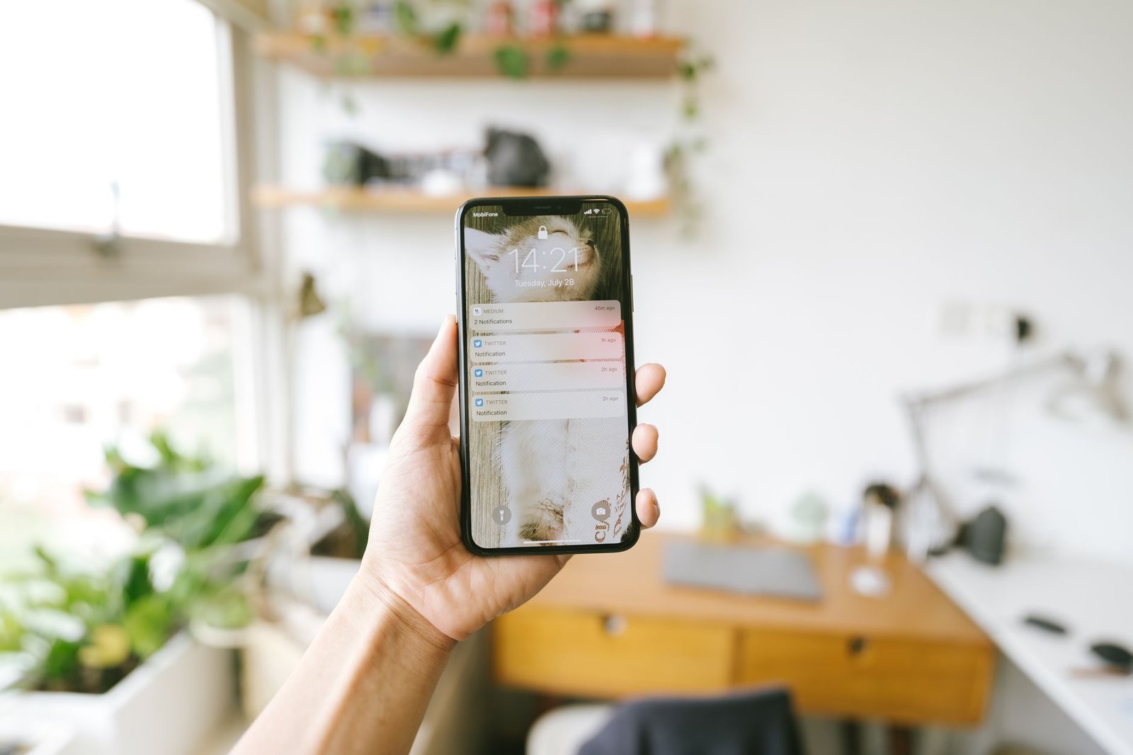 Close up of hands holding a phone with a message from a long distance partner