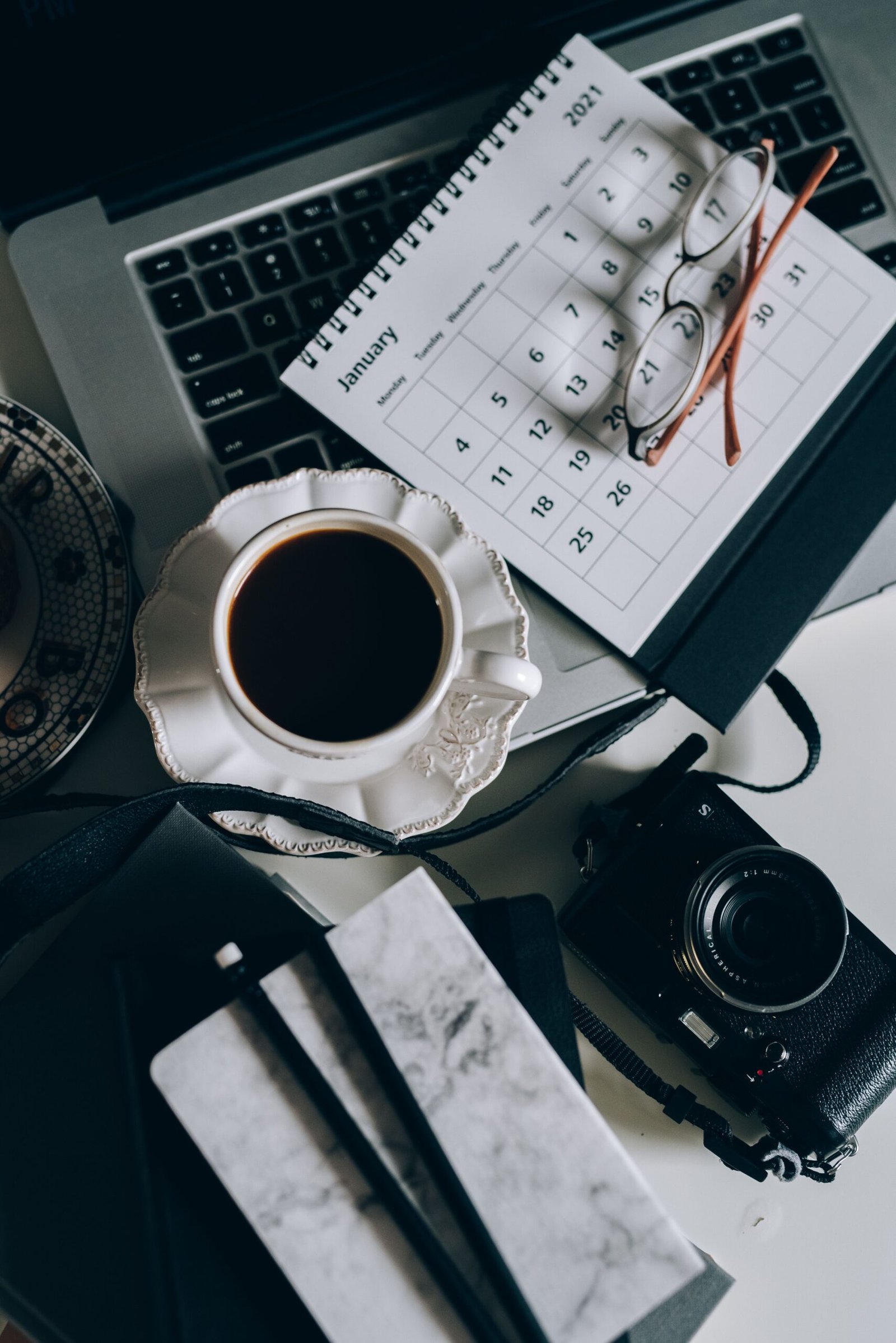 Shared calendar and paper planner open on a desk for couple scheduling