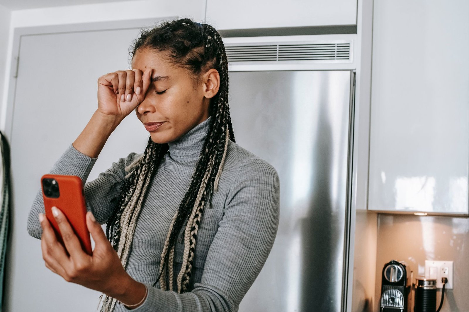 Woman looking at her phone feeling let down after a canceled date