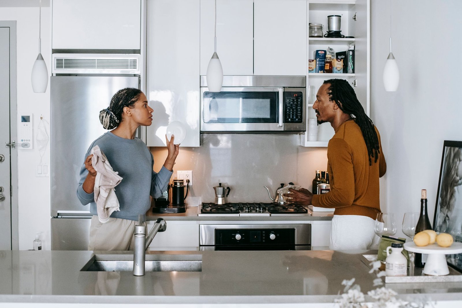 Couple talking in a kitchen about how many parties feel like too many