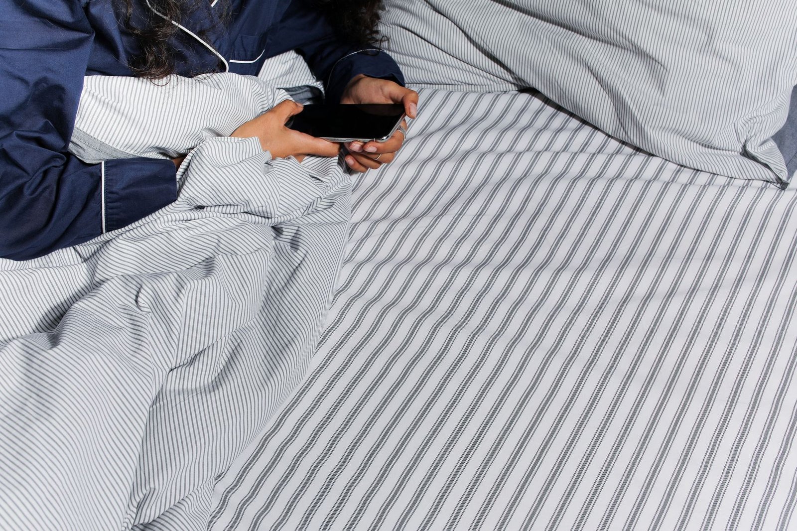 Woman texting on her phone at night