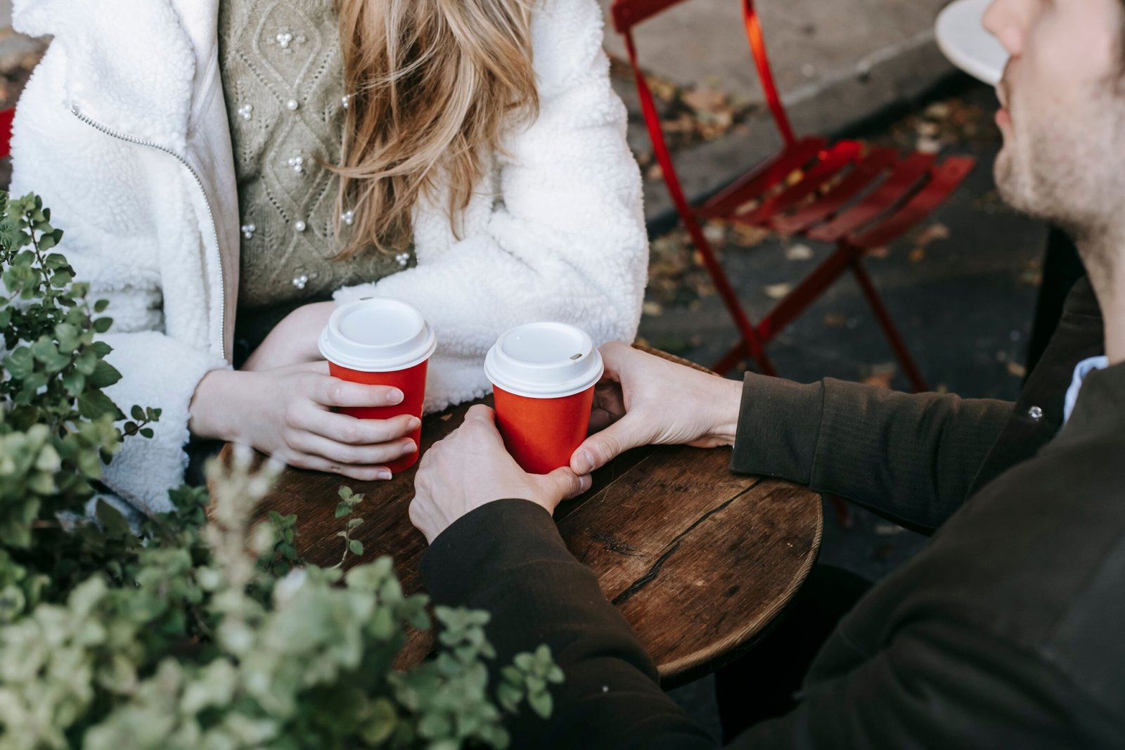 Couple talking over coffee at an outdoor cafe