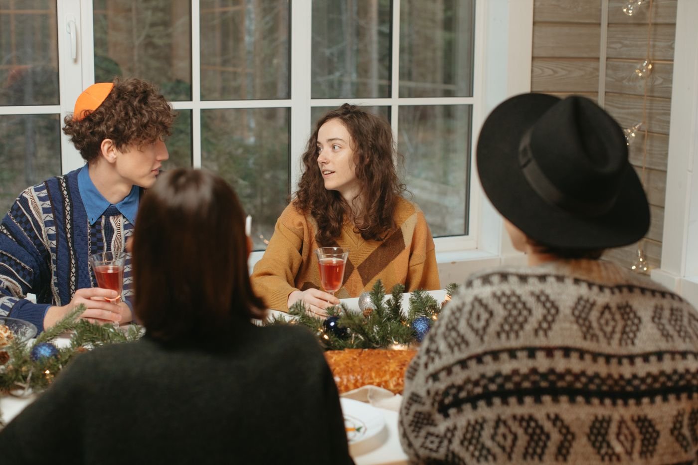 Family gathered around a holiday table, the moment many women bring up their long distance partner