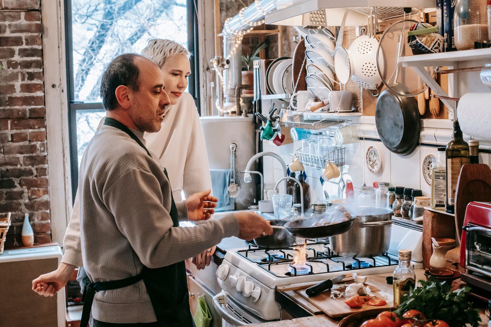 Man cooking dinner as an act of service for his partner