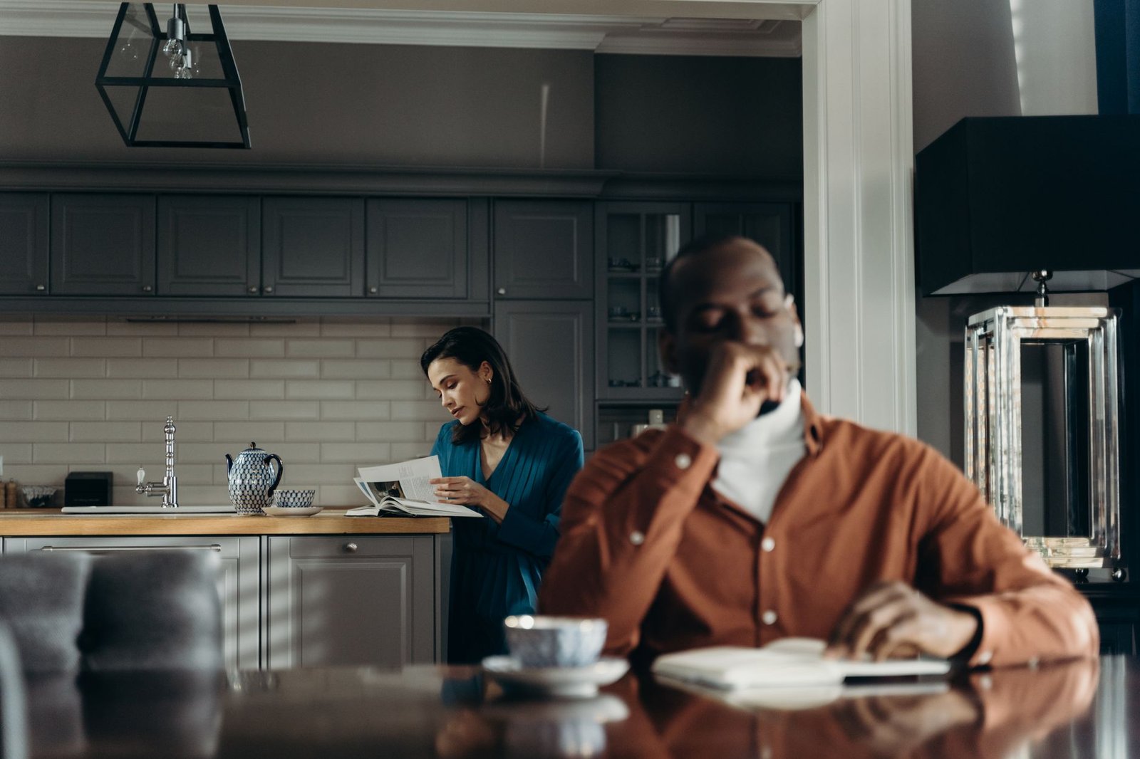 Couple relaxing with morning coffee in a living room they keep clean enough for both of them