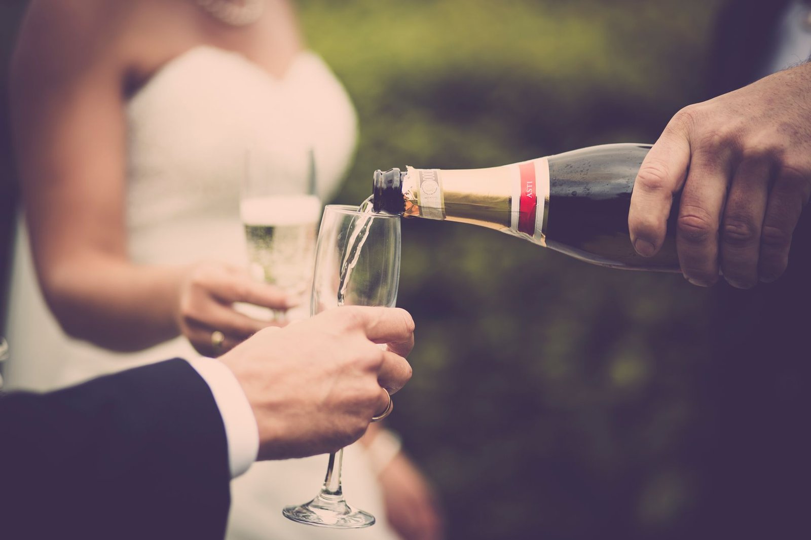 Wedding guests raising champagne glasses for a toast