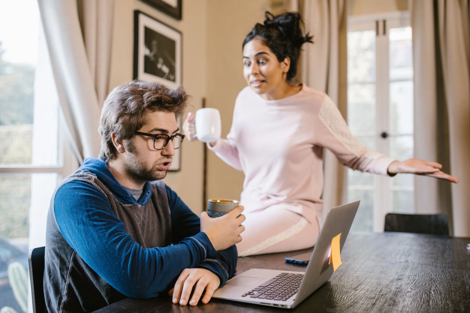 A couple talking through a hard conversation at home about phone privacy and trust