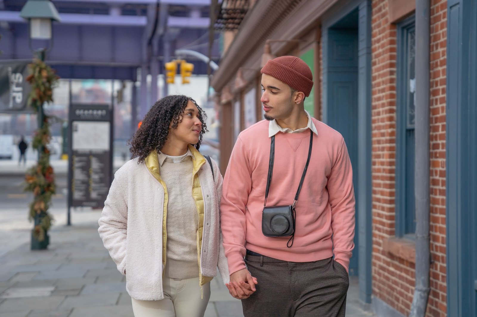 Couple walking together holding hands on a city street