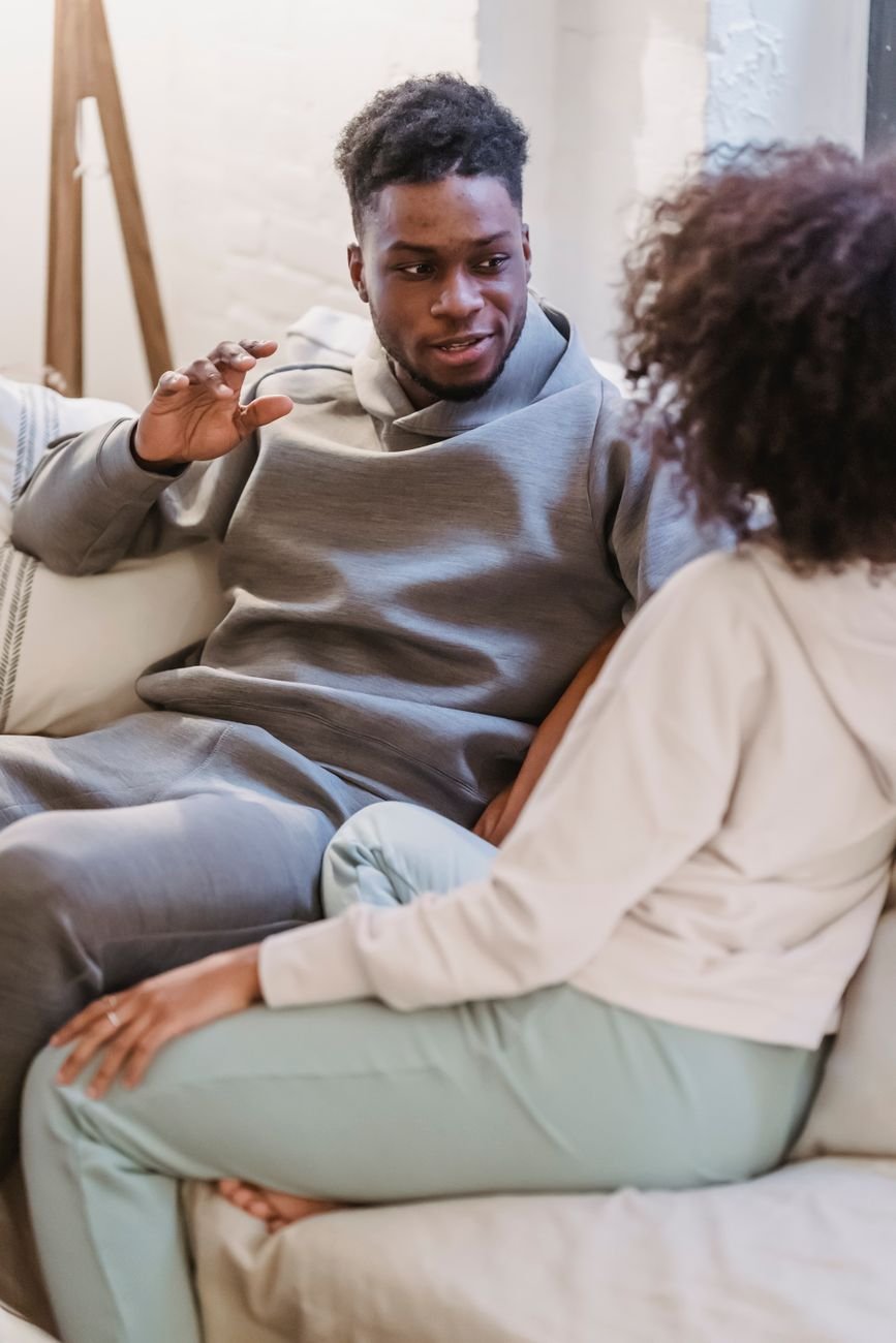 Woman talking calmly to her boyfriend at home while he listens instead of agreeing quickly