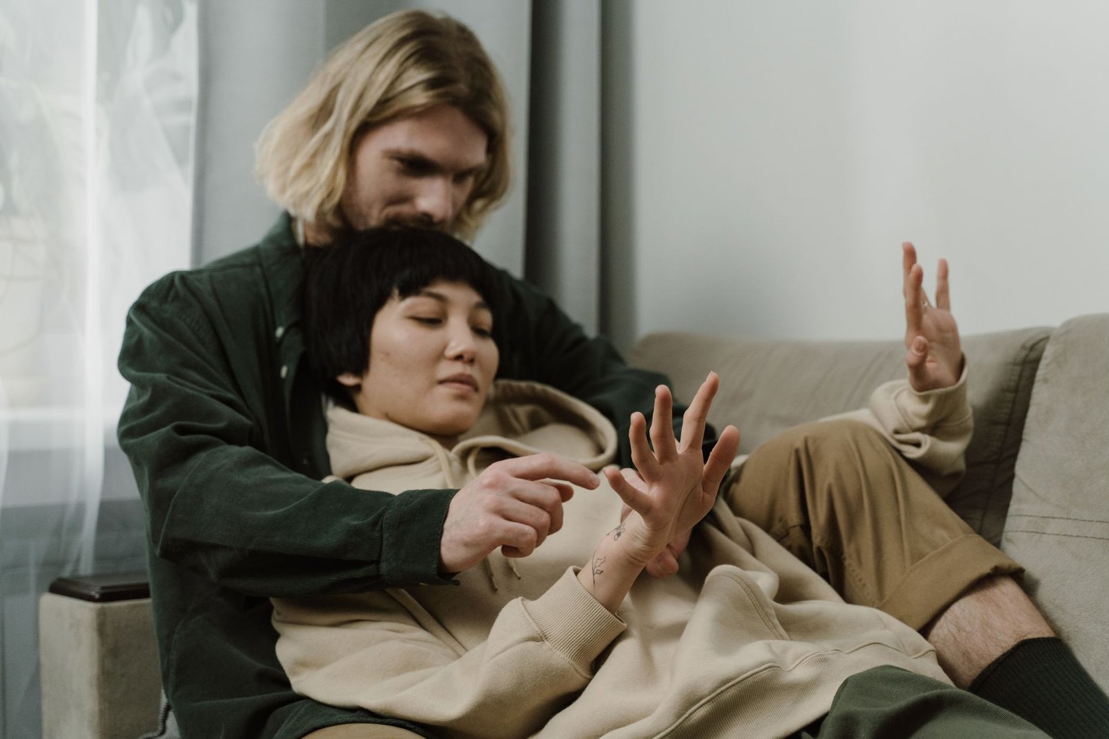Couple sharing a quiet, comforting moment on the sofa