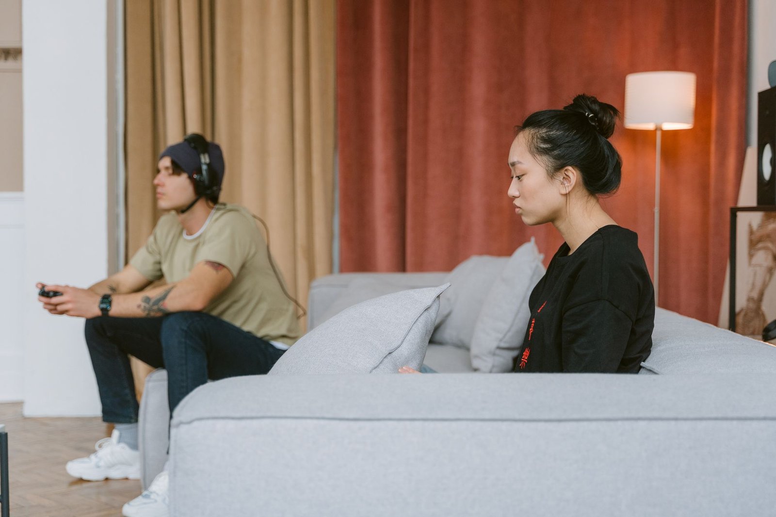 Couple sitting apart during a video call, showing distance in the relationship