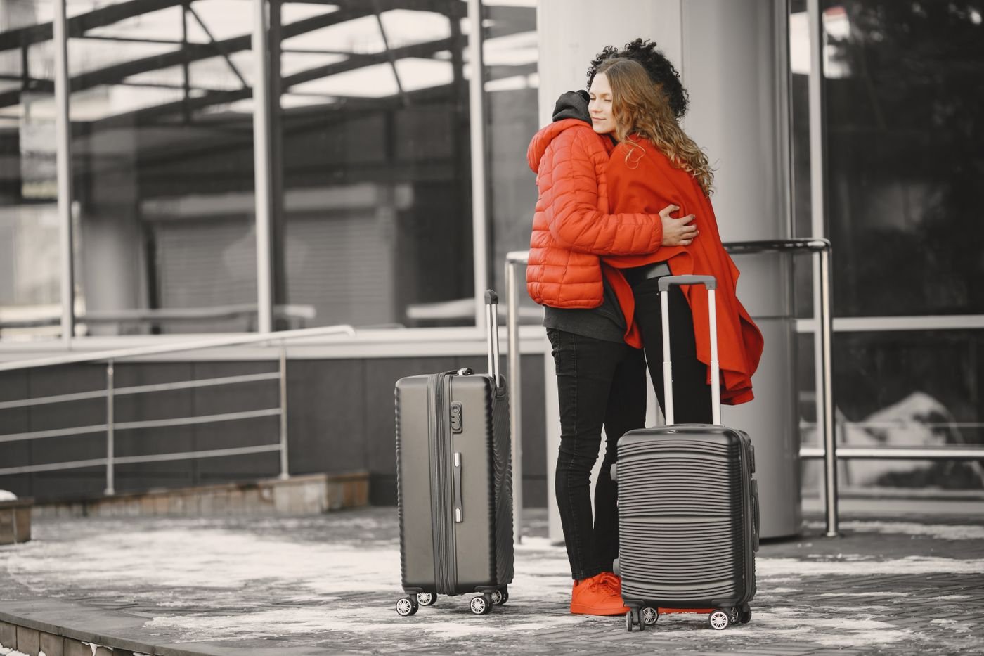Couple hugging goodbye at the airport at the start of a long distance relationship
