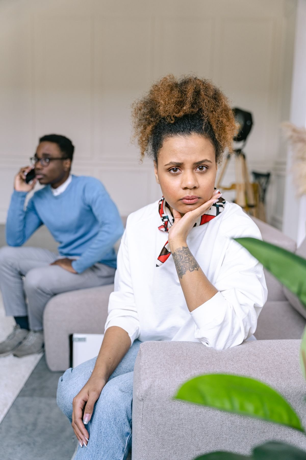 Thoughtful woman on a sofa deciding whether to open up to her partner