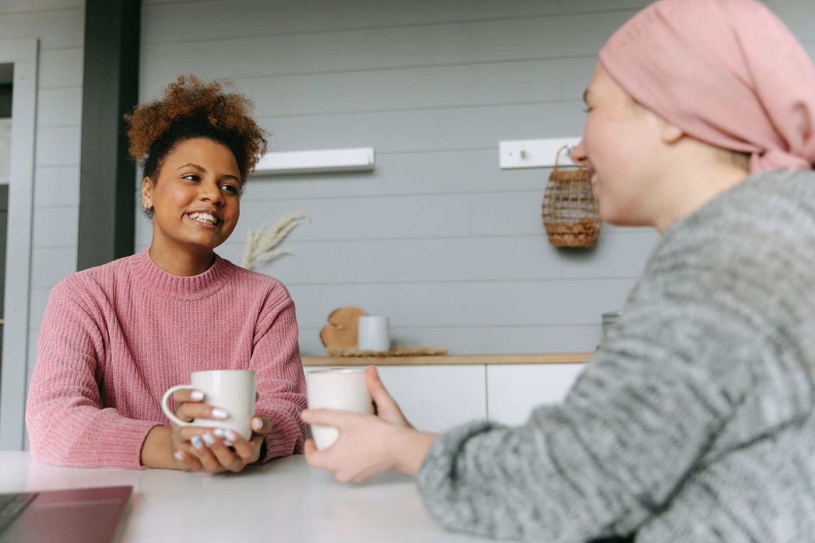 Two friends talking over coffee about moving on after a breakup