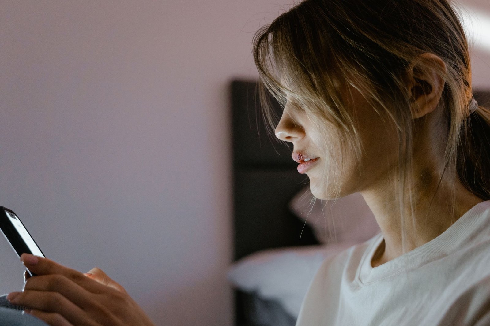Woman looking at her phone screen in low light