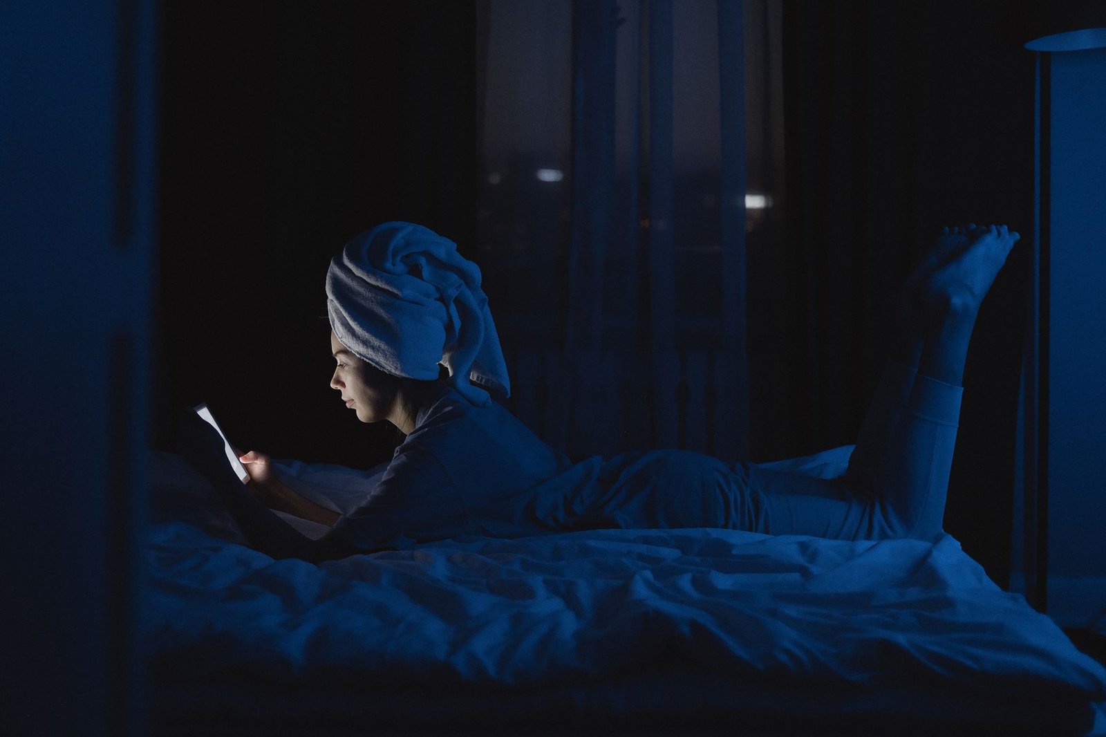 Woman winding down at night after a long distance goodnight call