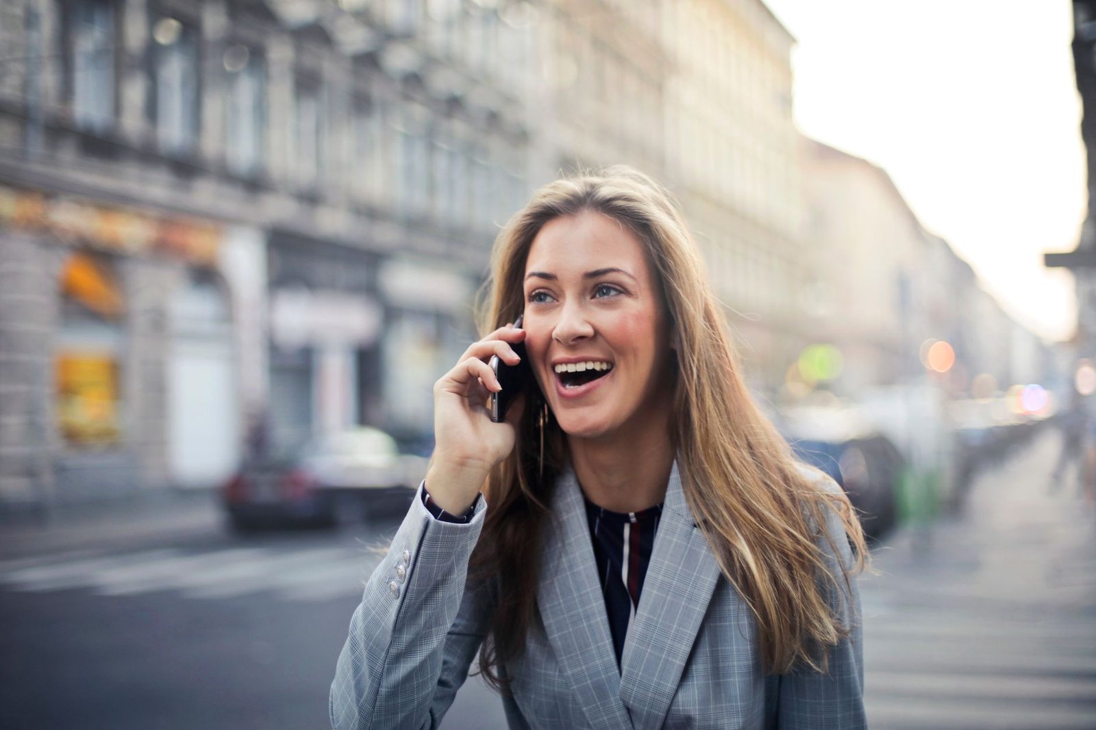 Woman laughing during a phone call with her long distance partner
