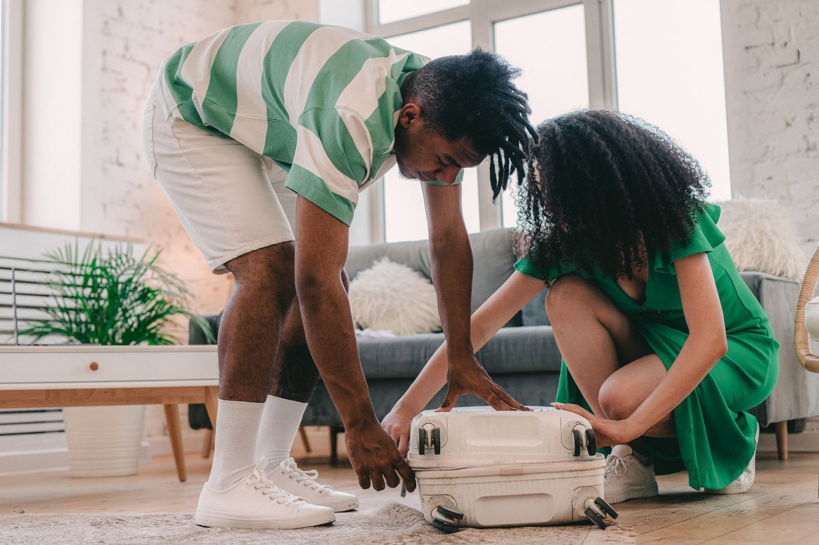 Couple packing a suitcase together while planning a long distance relationship visit