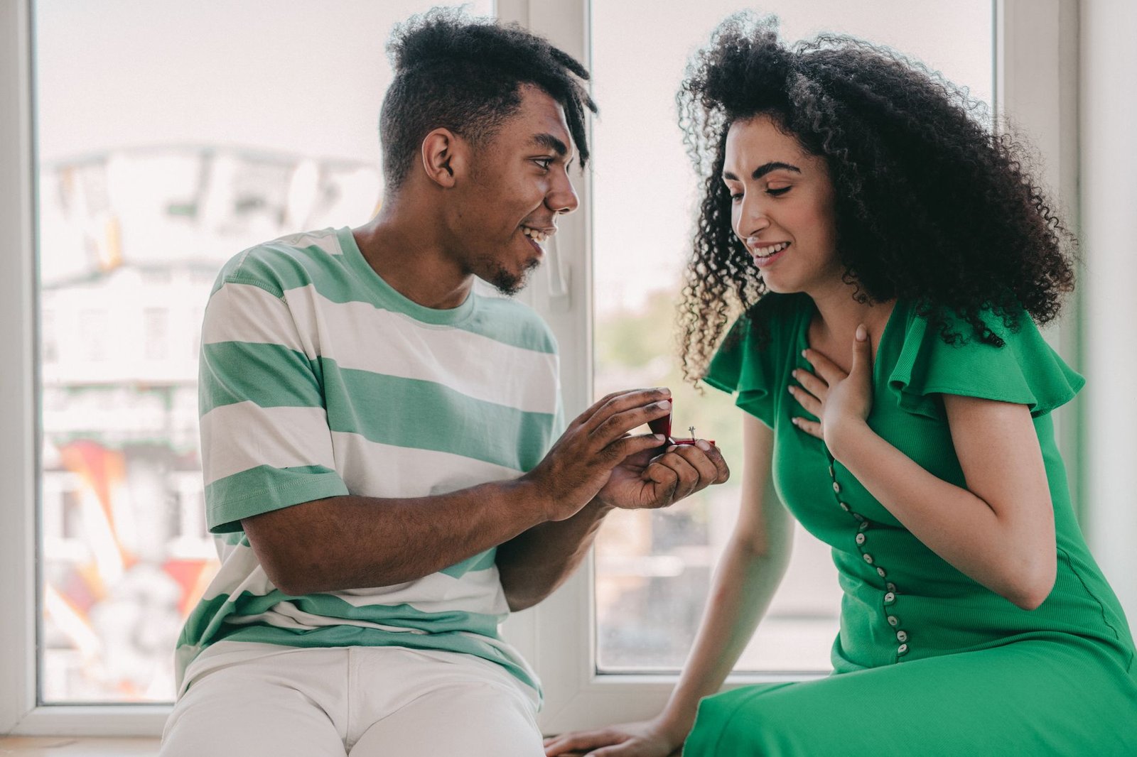 Couple sharing a quiet moment while telling her own family the engagement story
