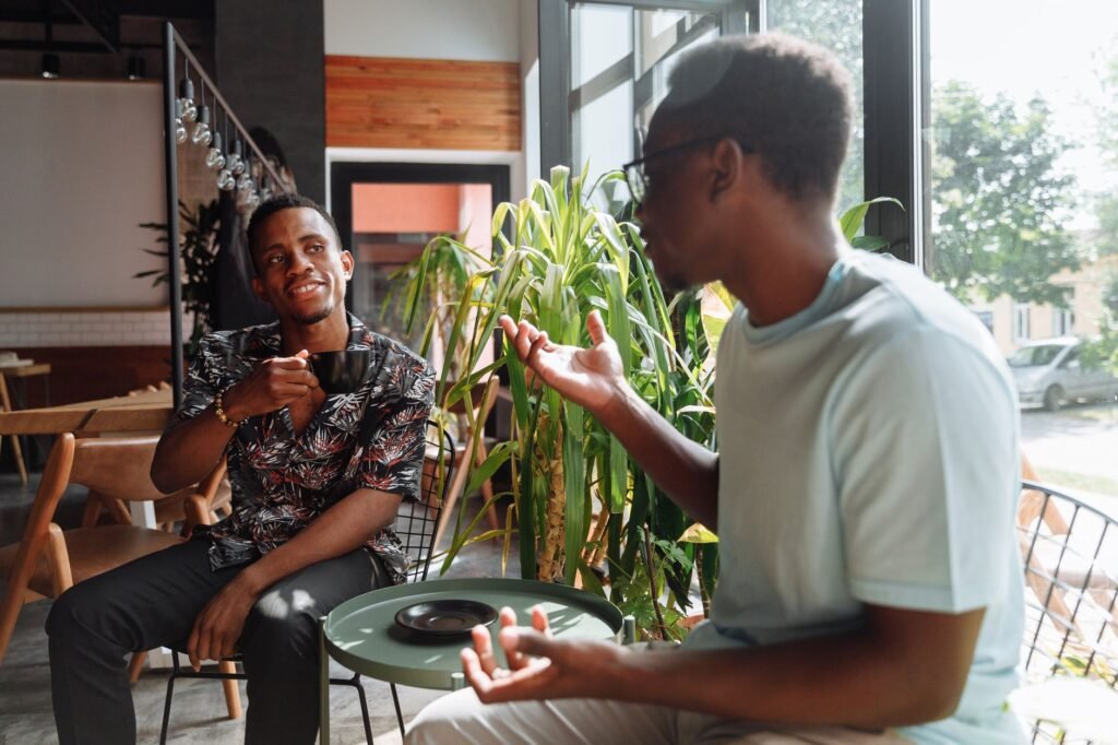 Two friends talking over coffee about a breakup and staying friends with an ex