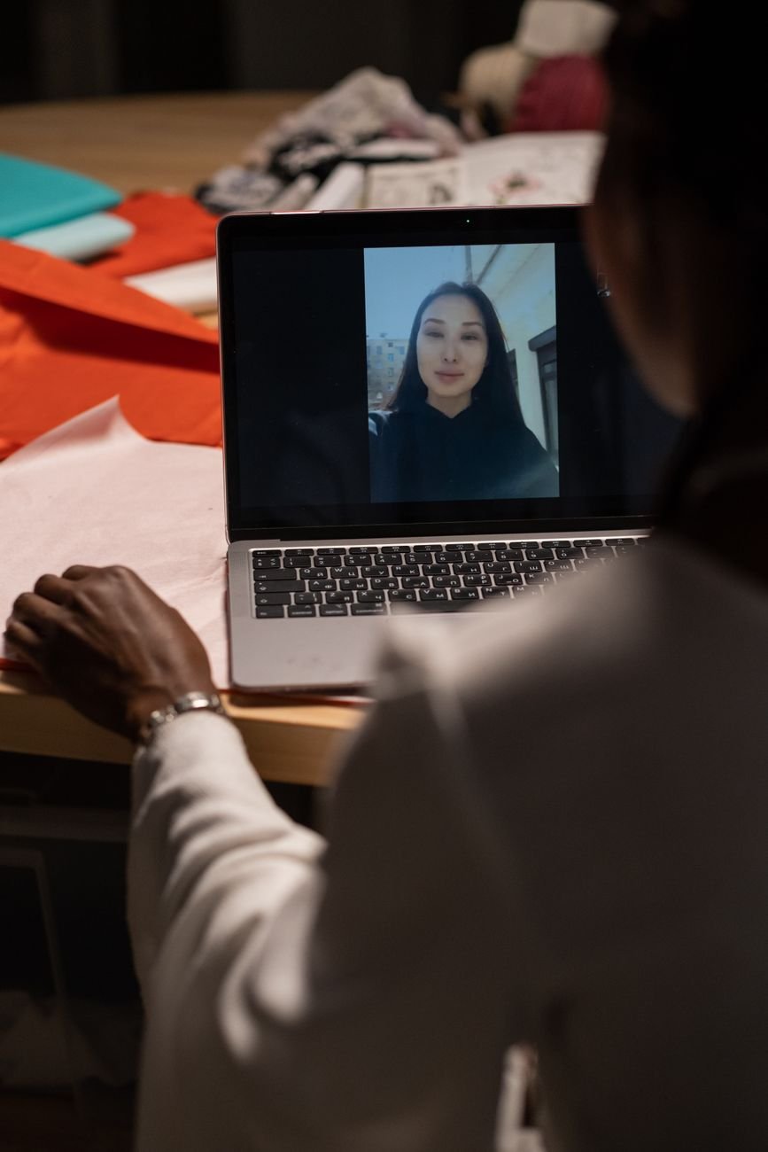 Laptop screen glowing in a dark bedroom during an emotional video call