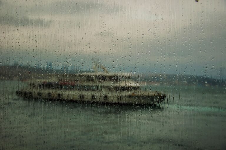 Woman looking out a rainy ferry window thinking about a move closer to his parents