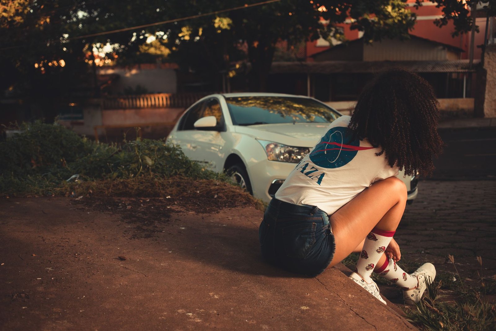 Woman sitting in a car outside an airport terminal on a dark winter morning before her flight