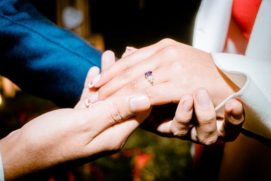 Woman admiring her engagement ring up close at home