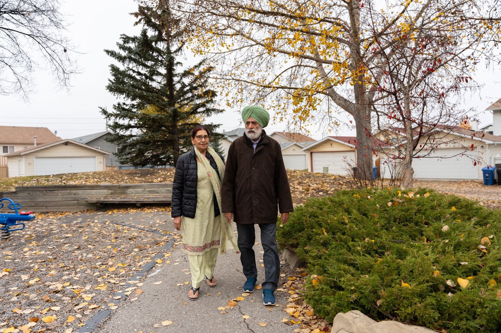 Couple walking through a small town main street on a visit home