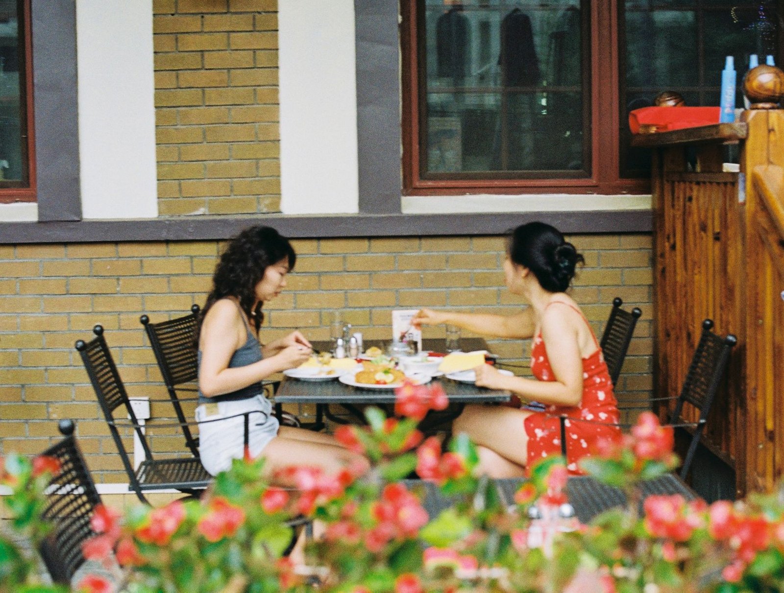 Couple at a sunny brunch patio table where the boyfriend is rude to waiters but sweet to his girlfriend