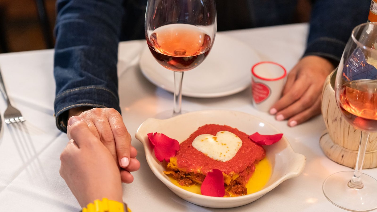 Couple sitting in silence at an Italian restaurant after an unfair comment